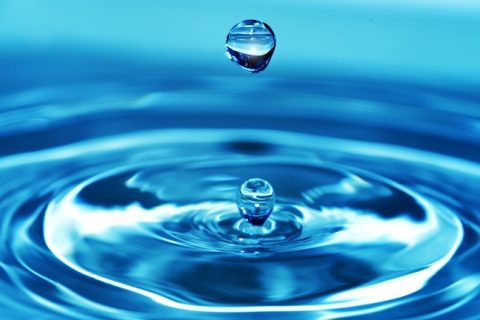 Splash water. Bright blue background